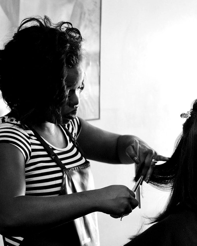 Stylist trimming a client's long hair